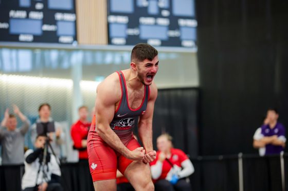 Brock's Wrestling - a wrestler celebrates a win with an emotional expression and hands clenched in enthusiasm.