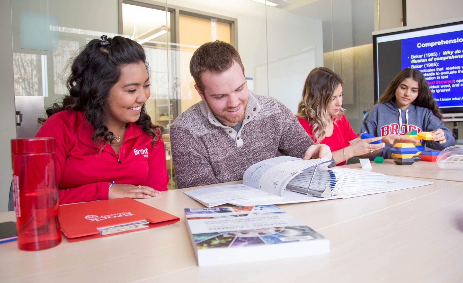 A group of students sit together studying at Brock University. 