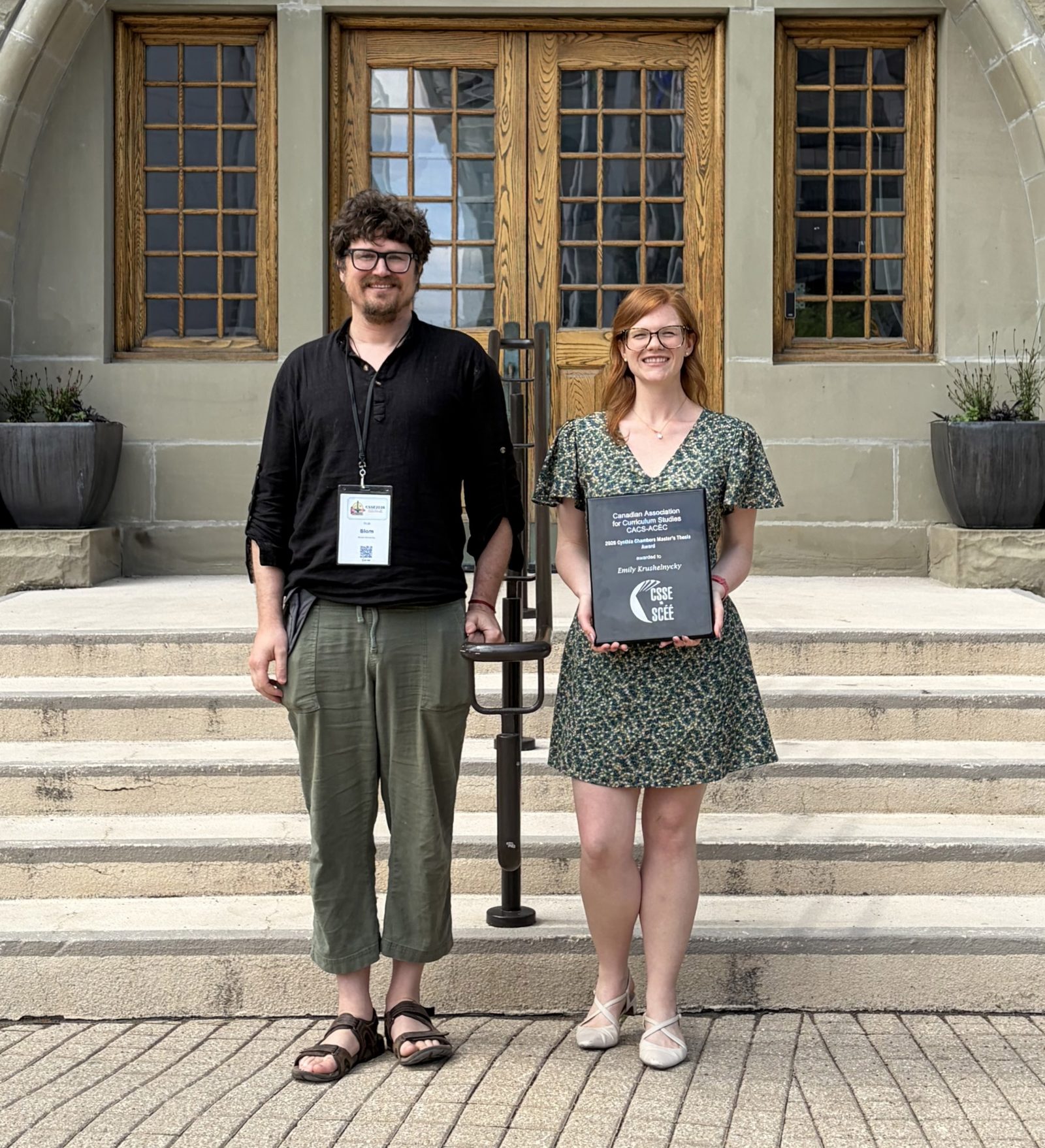 Rob Blom and Emily Krushelnycky stand together outside University of Winnipeg.