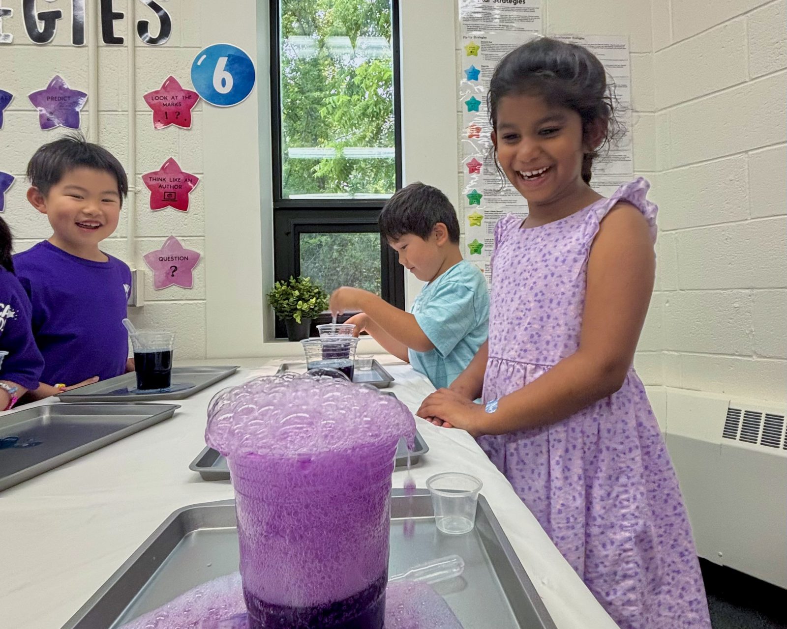 Three young learners do a science experiment at the Brock Learning Lab. 