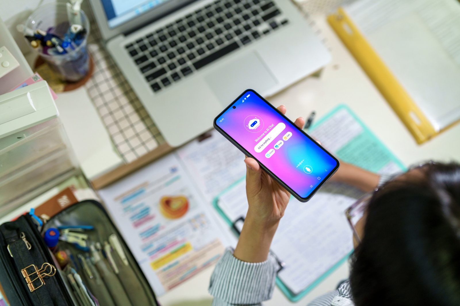 A young person looks at a phone. 
