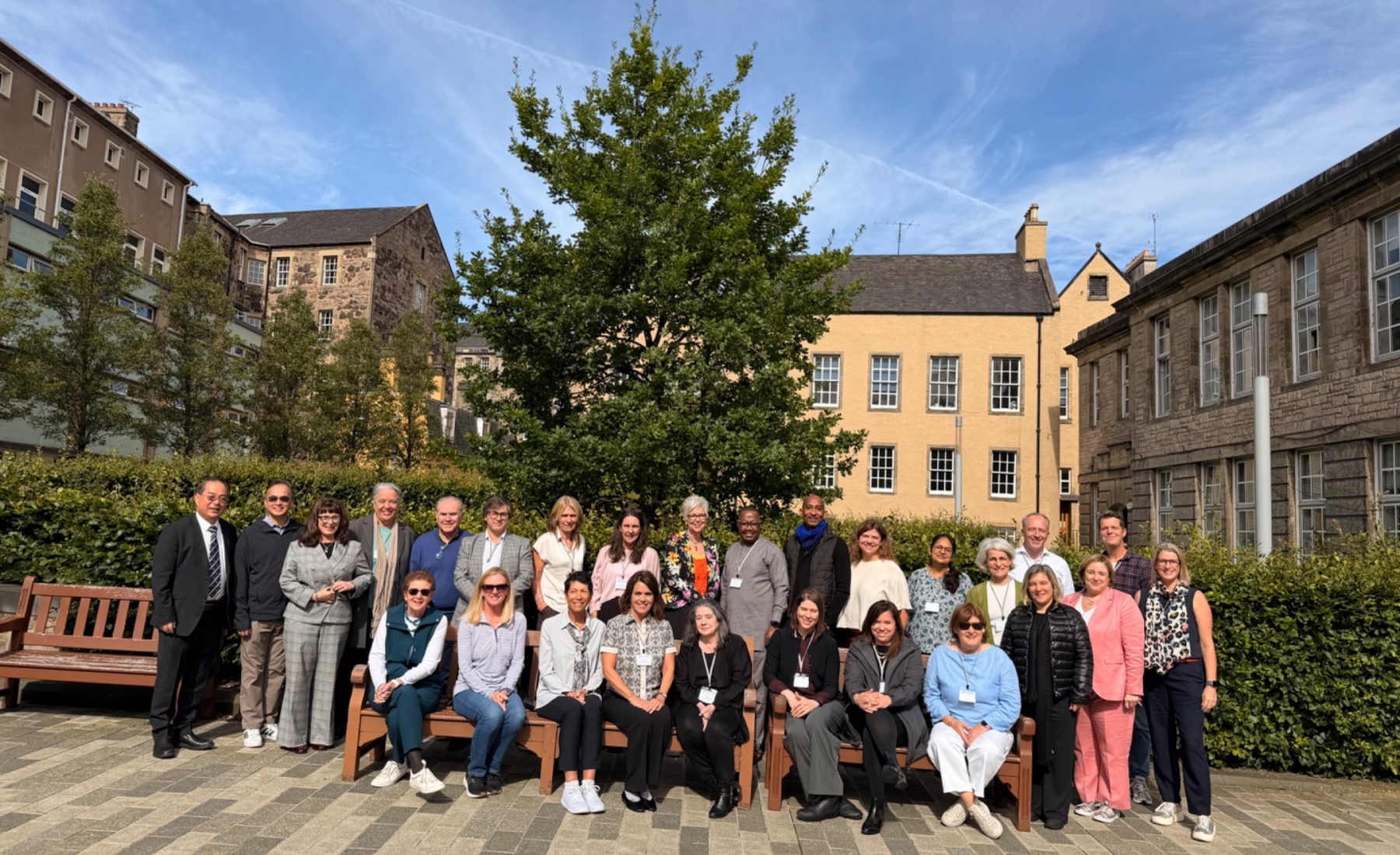 A large group of Faculty of Education Deans stand outside in Edinburgh, Scotland. 
