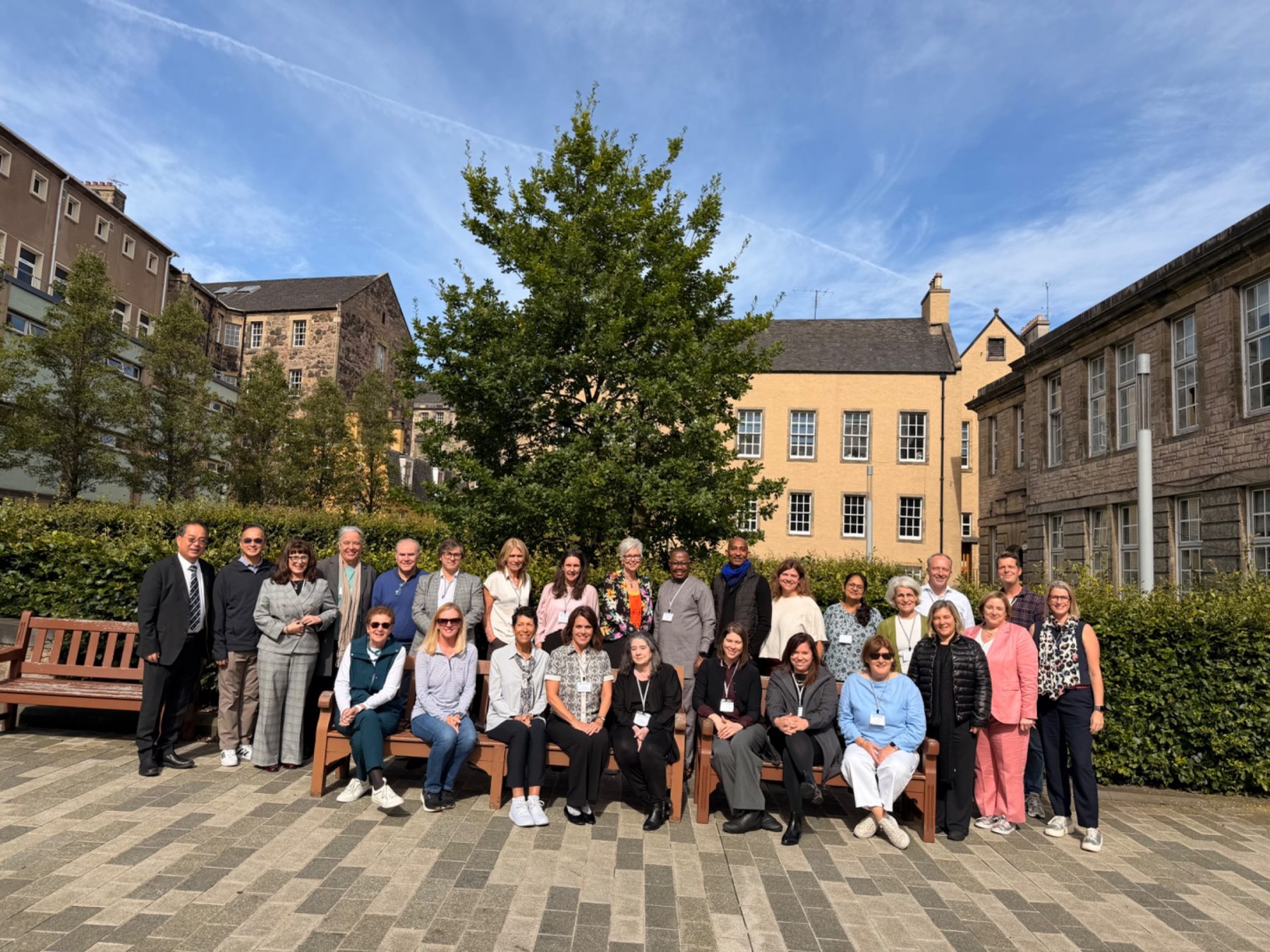 A large group of Faculty of Education Deans stand outside in Edinburgh, Scotland.
