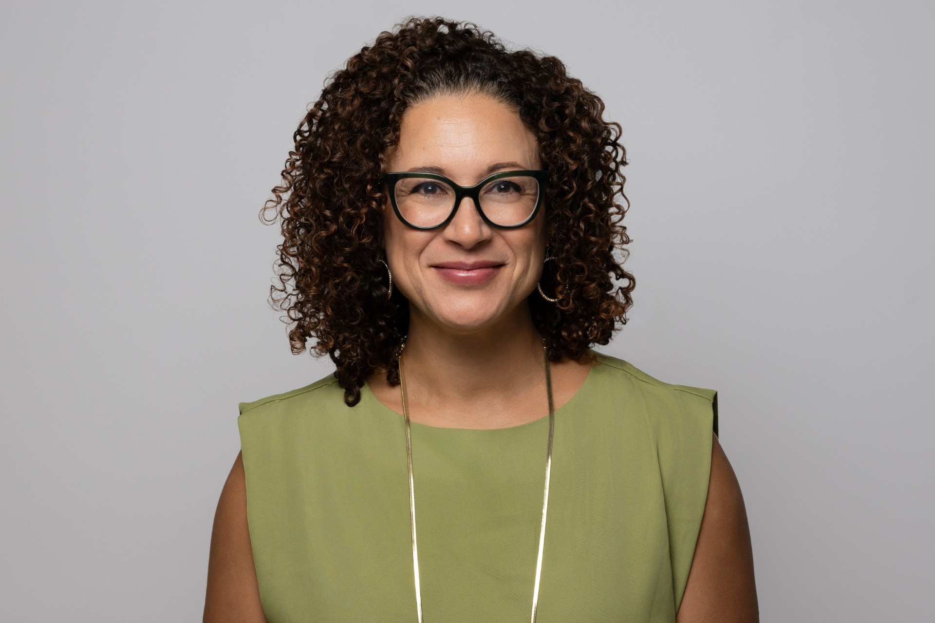 A woman smiles at the camera.