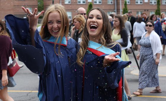 Brock Concurrent Teacher Education throw confetti at Convocation