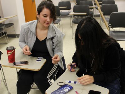 Two Brock students working on a Two Row Wampum Belt in class