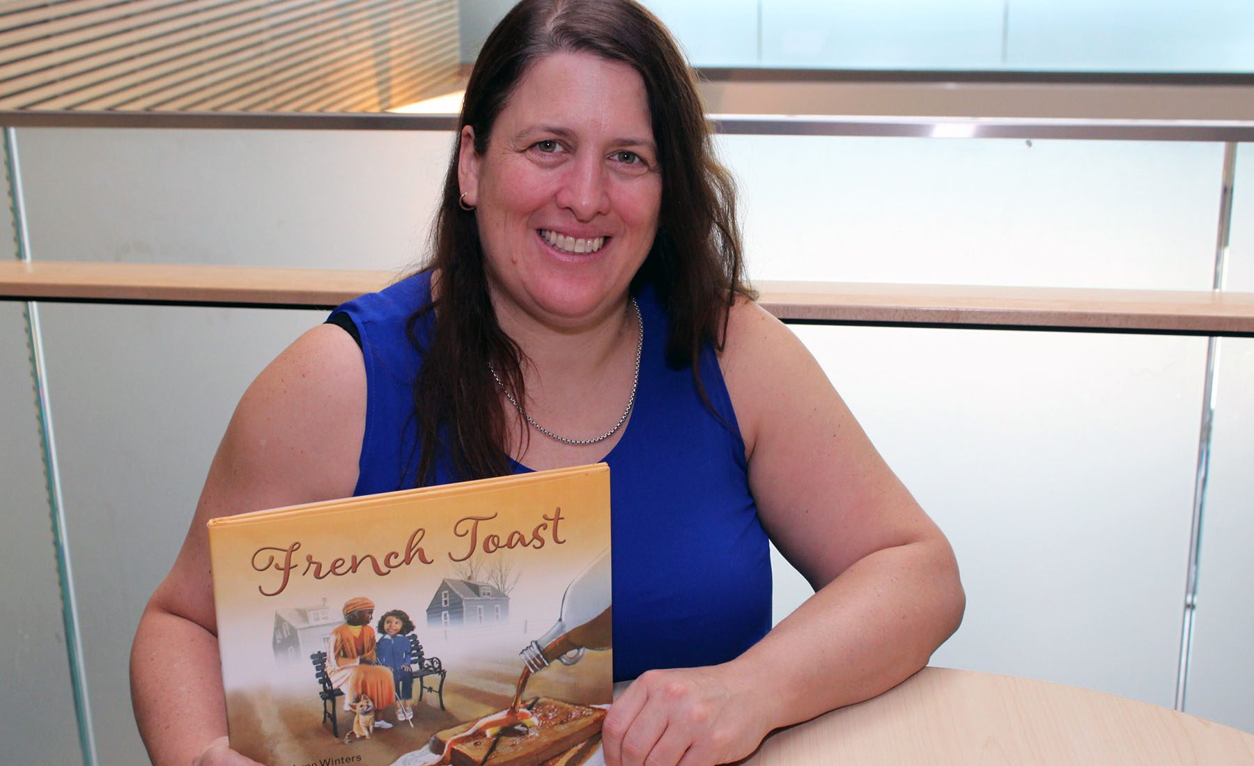 Associate Professor Kari-Lynn Winters shows off the cover of her recent children’s book French Toast.