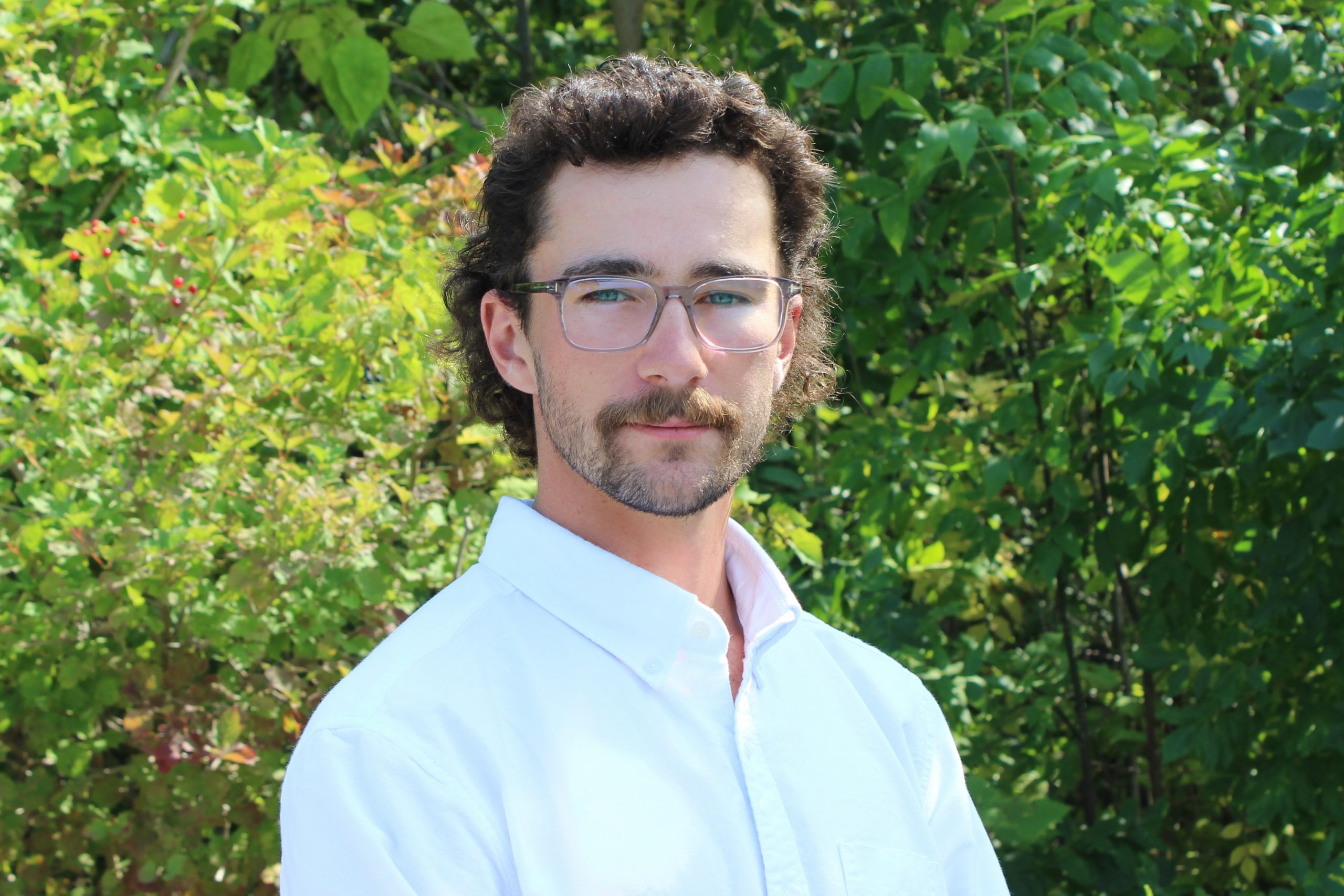 Coughler Final Joseph Coughler standing in front of trees.