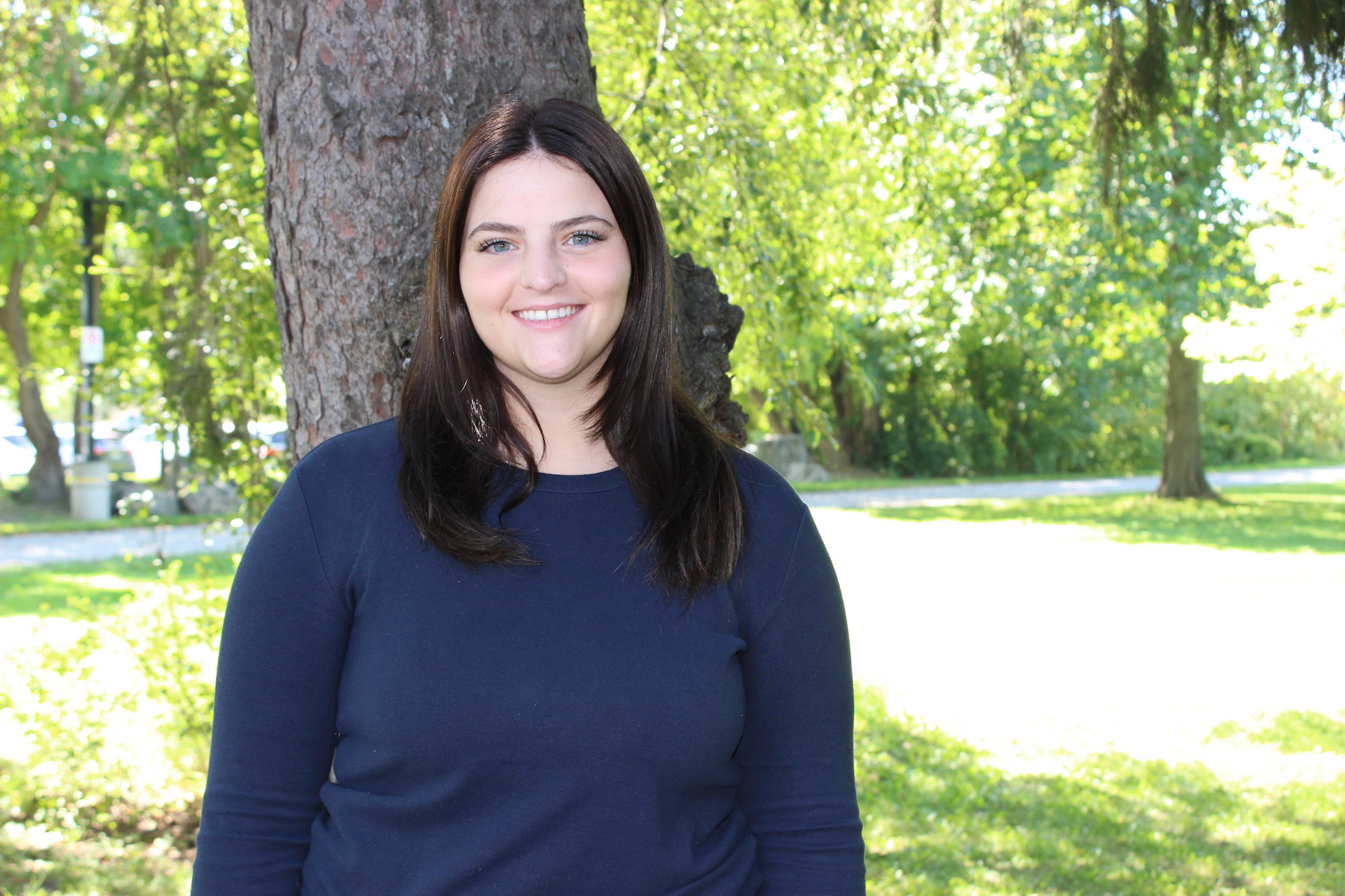 Jordan McNeillie standing in front of a tree.