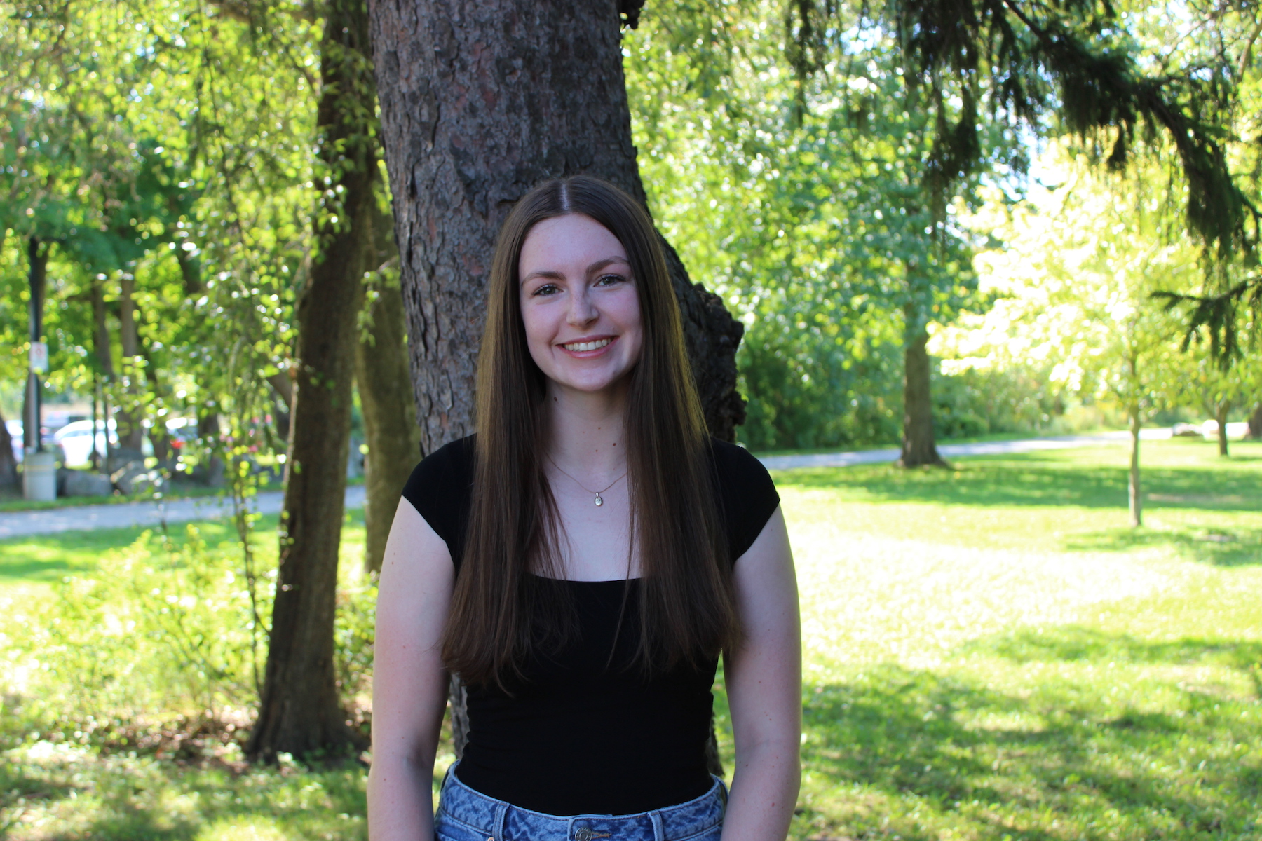 Alison Laurie standing in front of a tree.