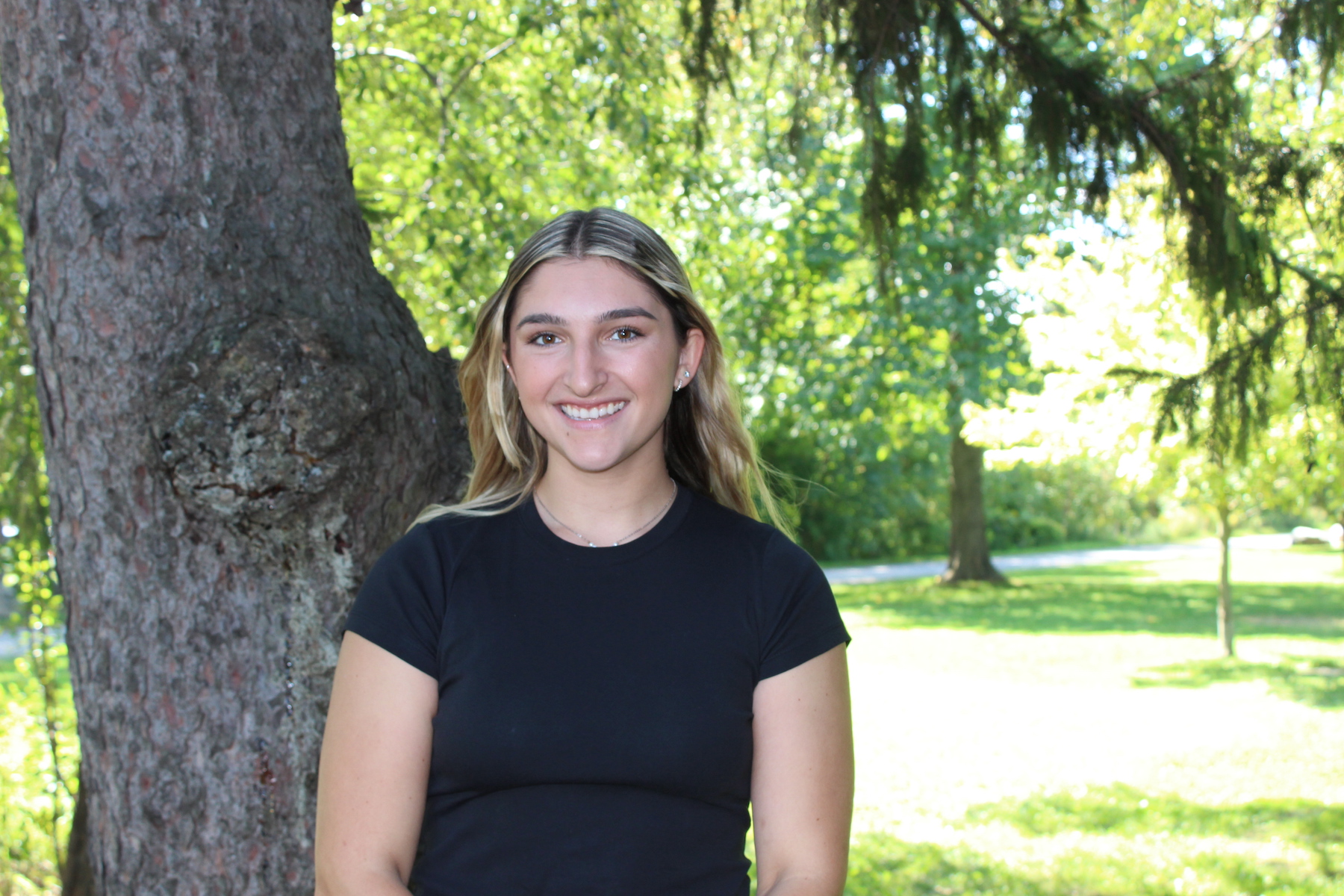 Bridget Matthews standing in front of a tree.