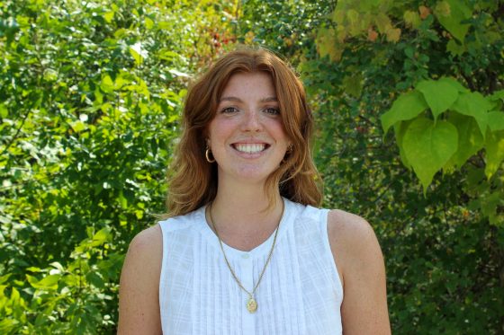 Makenna Kollo standing in front of trees.
