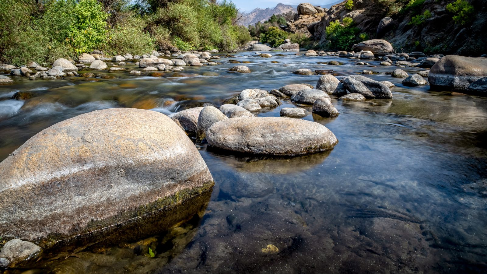 A creek full of water and rocks.
