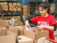 Brock Cares student loading food into donation boxes