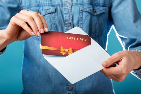 lose-up Of Person's Hand Holding Gift Card