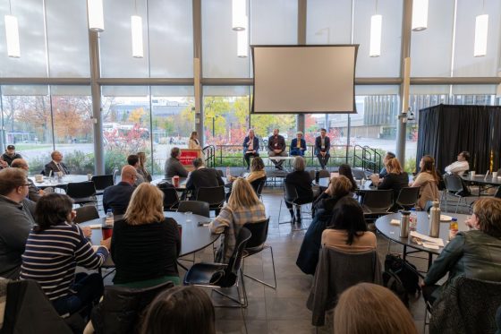 Four Professors sitting on a panel for discussion