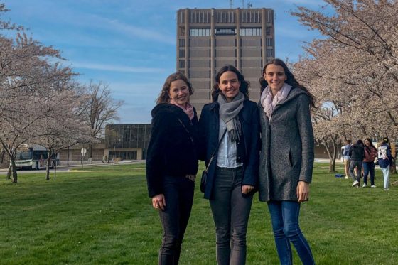 IPBS club founders from left: Carina Hohenadel, Julia Gralka, and Elke Neumann stand in front of Schmon Tower 