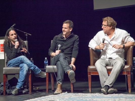 Three panelists sitting in chairs onstage at Music Matters discussion