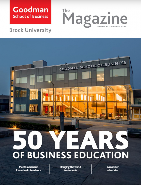 A photo of the Goodman Atrium from the outside at dusk with text overlay, "50 years of business education"