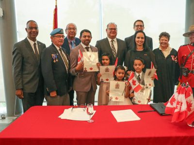 Minister sitting with Brock Delegates