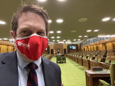 Man wearing a Brock University red face mask