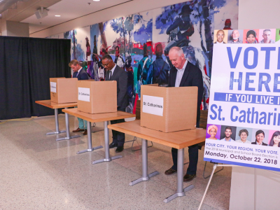 voting booths with man casting his vote