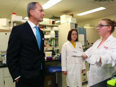 Minister with a Brock Delegates in a lab space
