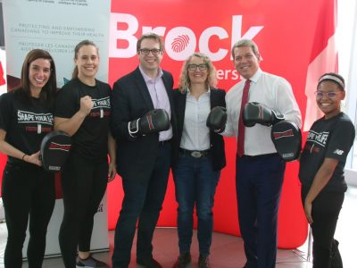 people in front of a Brock University backdrop