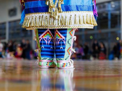 A close up look at a women's regalia and moccasins.