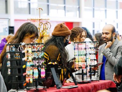 A group of people shop at Indigenous Vendors.