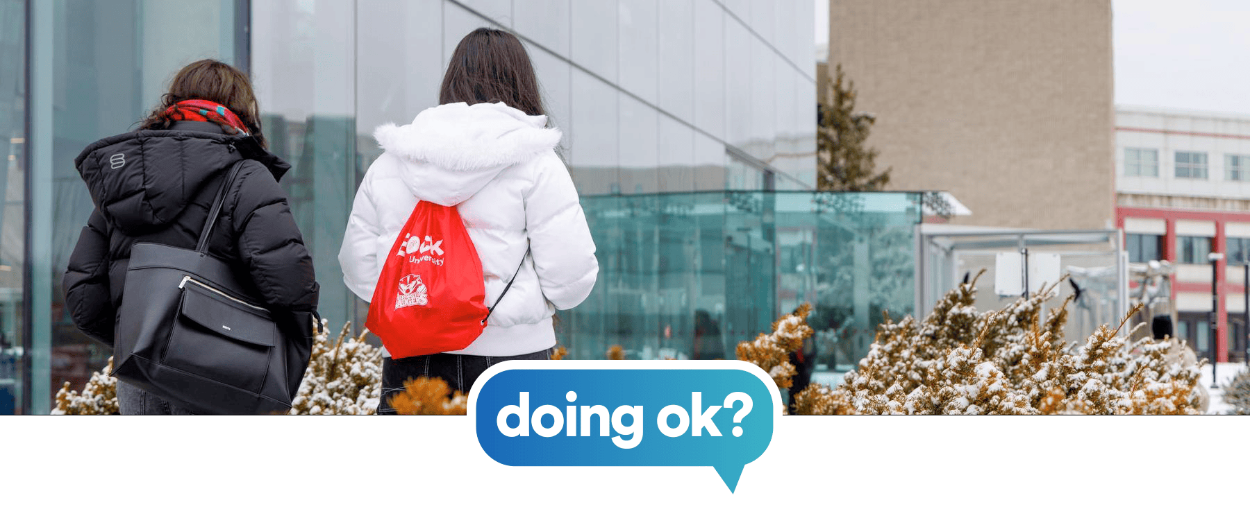 students walking to Brock University with the doing ok logo