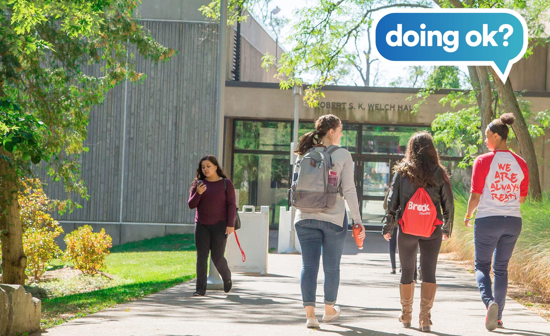 students at Brock University walking toward Welch Hall 
