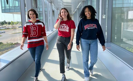 Three Brock University students walking in hallway
