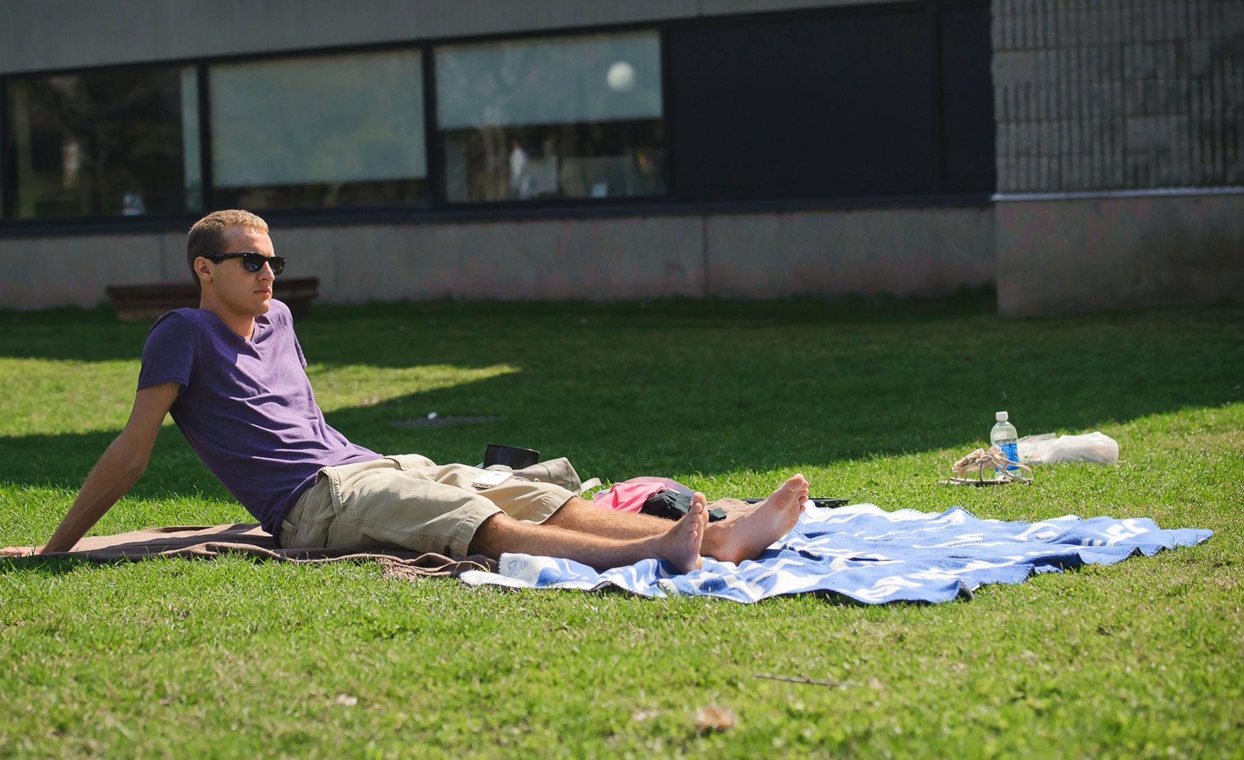 Male student laying out on blanket