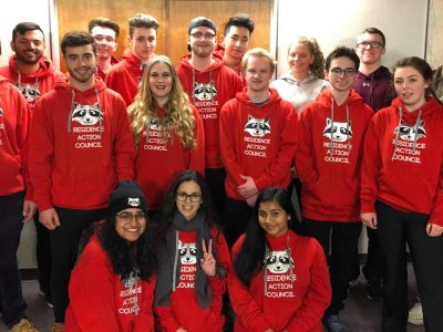 Group photo of RAC members wearing red RAC sweatshirts