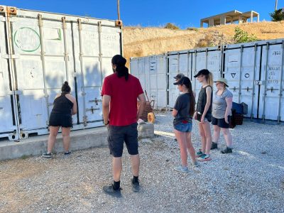 6 Students in front of a metal shipping container
