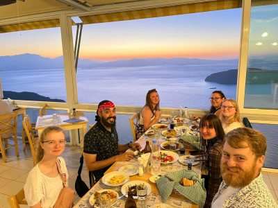 7 students enjoying dinner and the sunset at Panorama