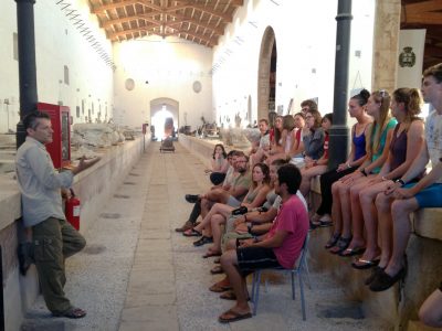 Marzamemi in an ancient building sitting on benches listening to professsor