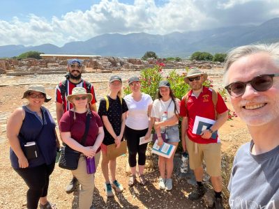 Prof Smith taking a selfie with 7 sstudents at Malia
