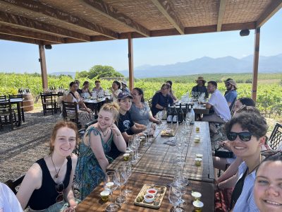 group of students on a Study Tour of Greece at table waiting for food