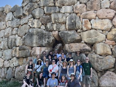 Study Tour of Greece group of students in front of a large ancient wall