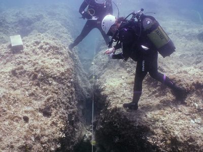 Marzamemi 2 scuba divers looking at a small trench
