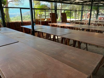 wooden tables setup in a fenced in area at Gournia