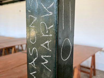 Masons mark written in chalk on a black steel pole in Gournia