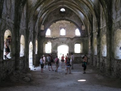 The group explores a church in the abandoned village of Kayaköy