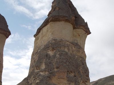 Miriah, Kristen, and Kristin dwarfed by a fairy chimney at Paşabağ