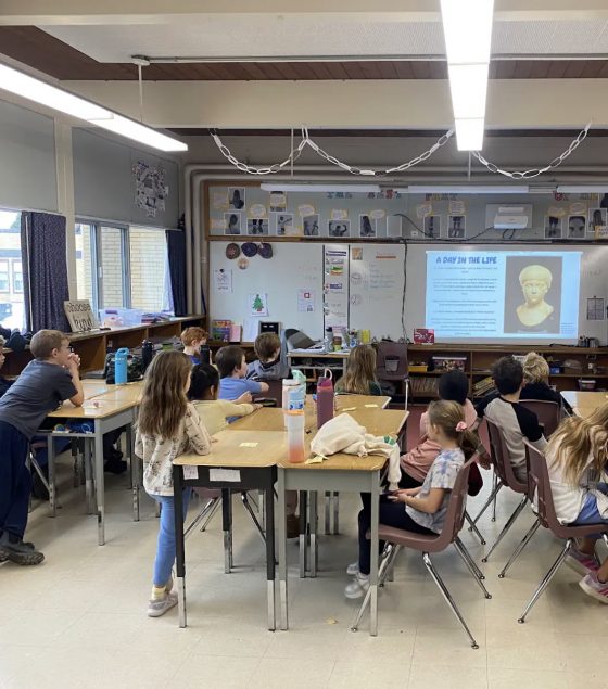 Students in a classroom learn about the Roman world