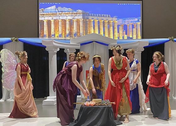 Students perform and ancient play