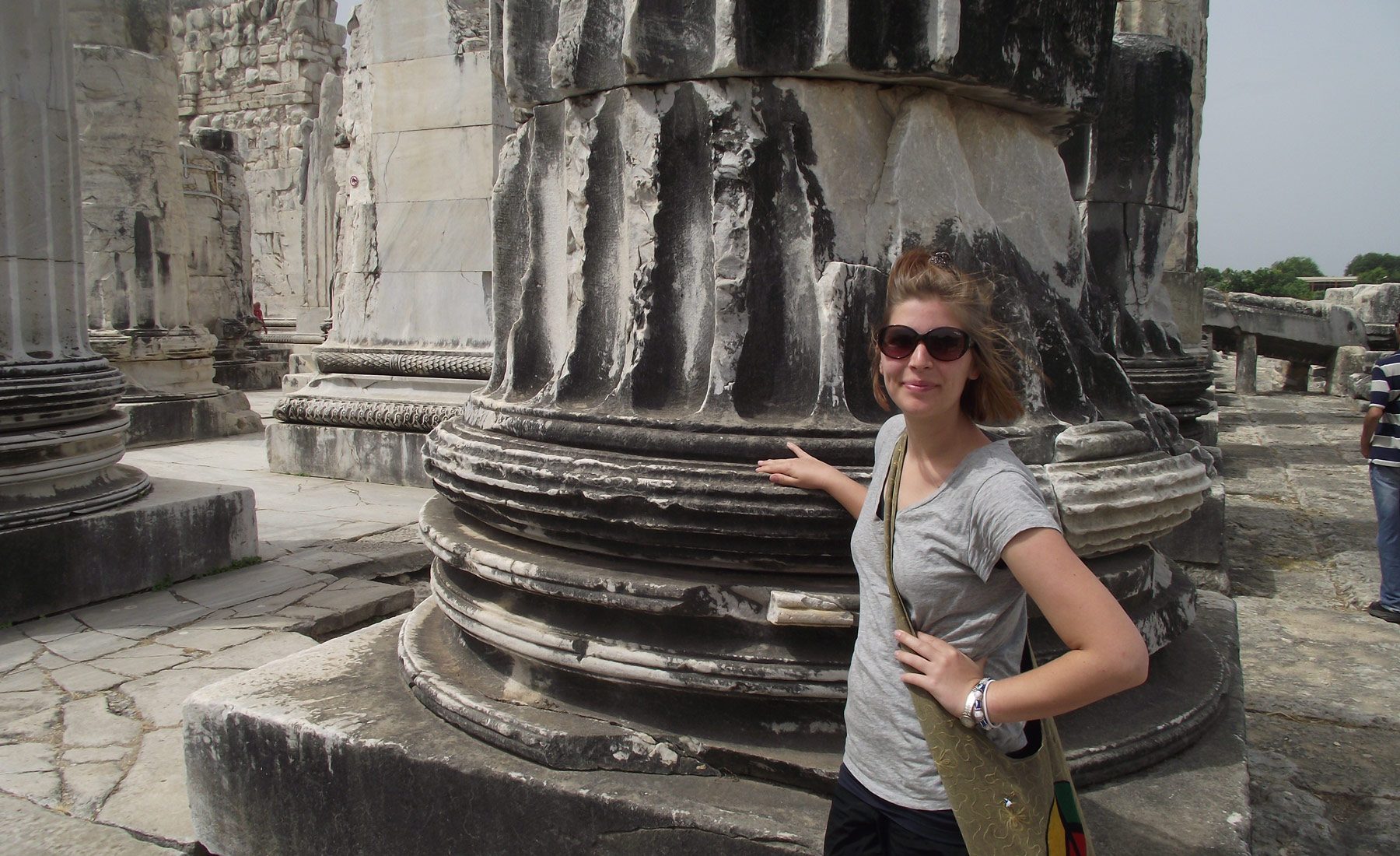 Woman at the base of an ancient column