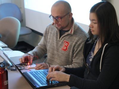 2 students hard at work on laptops